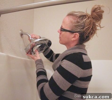 Attaching the New Shower Head Installing the new shower head by screwing it onto the prepped shower arm.