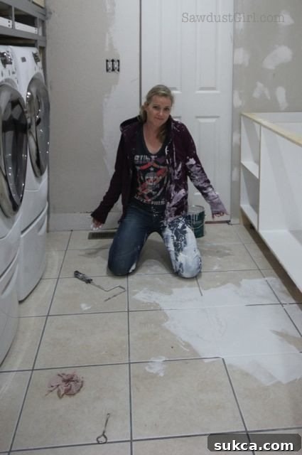 Painting blunder: A wide shot captures the chaotic scene of a large paint spill spreading across a wooden floor, creating an immediate sense of DIY disaster.