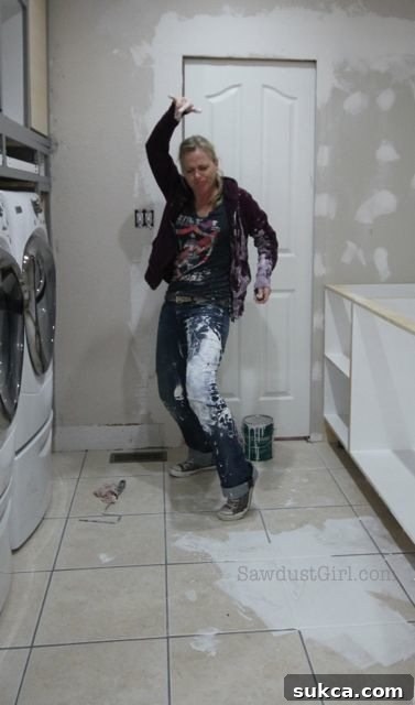 Painting blunder: A wide shot captures a person mid-dance, covered in paint, amidst the extensive paint spill, embodying a joyful and humorous response to the disaster.