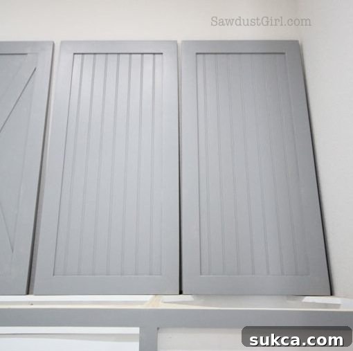 Finished Laundry Room Cabinet Doors - Summit Grey Beautifully painted laundry room cabinet doors in Sherwin Williams Summit Grey, showcasing the clean, finished look.