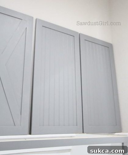 Beadboard vs X-Pattern Cabinet Doors Comparison Comparison shot of two painted laundry room cabinet doors: one with a classic beadboard design, the other with a modern X-pattern.