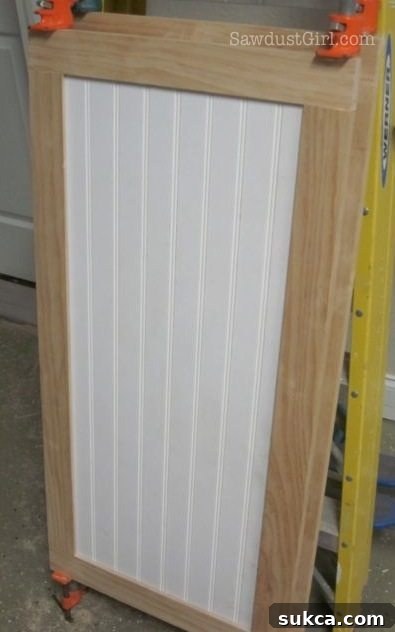 Inserting the door panel and clamping the final frame assembly