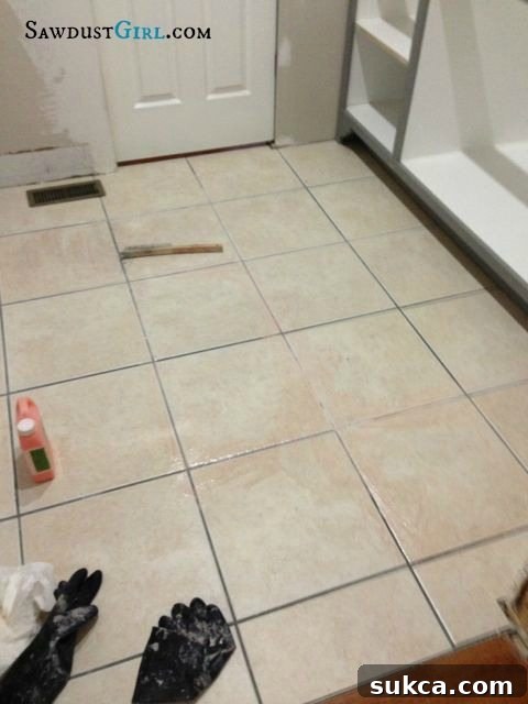 Close-up of tile and grout showing significant progress in paint removal