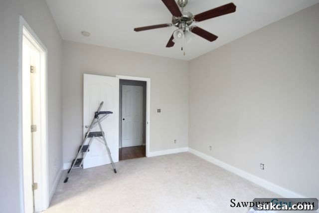 Another view of the empty room, highlighting a corner, ideal for built-in shelving or a custom desk configuration.