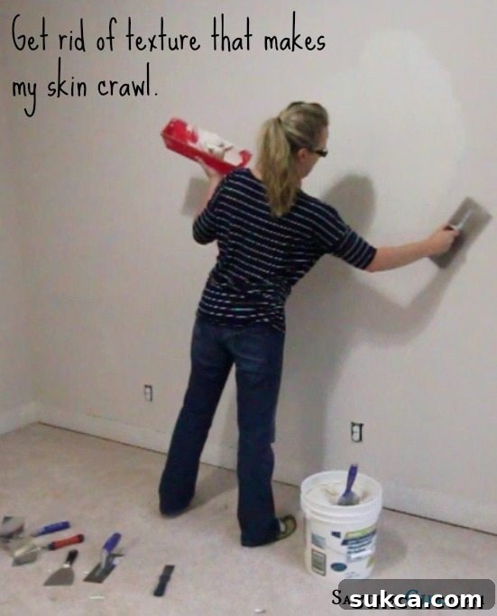 Close-up of skim coating in progress on an office wall, illustrating the technique for achieving a smooth finish.