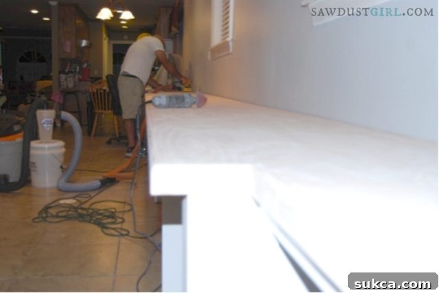 Final sanding for a silky smooth countertop surface Husband sanding the oak plywood countertop top with 220 grit sandpaper