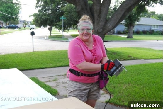 A proud moment with my pink tool belt (and a reminder to focus!) Author wearing a pink tool belt while working on office built-ins