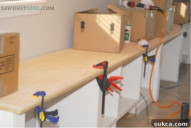 Ensuring a strong bond for the countertop Close-up of oak plywood being installed, showing nail placement