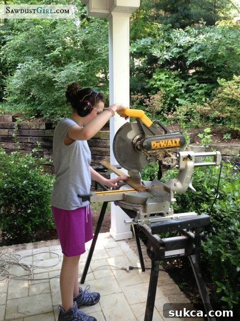Teaching tool safety to my daughter Madison learning miter saw safety during flooring project