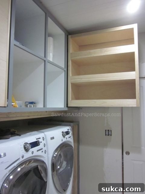 Smart pull-out storage cabinet in a laundry room, offering pantry-style organization and easy access to essentials.