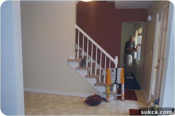 Custom newel posts and wainscoting in staircase remodel
