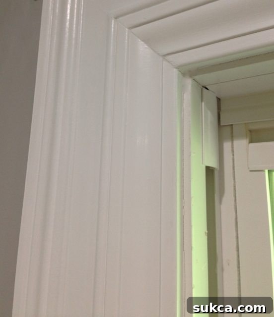 Wide door and window trim molding created by layering two styles of trim together.