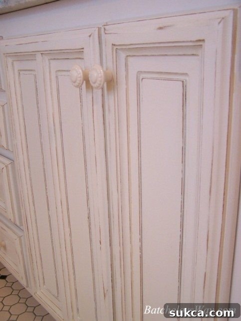 Custom cabinet with repurposed old doors and new porcelain knobs, highlighting furniture upcycling