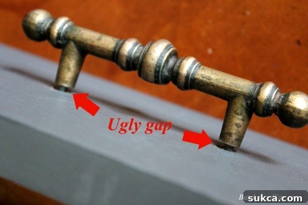 Demonstration of a gap between furniture hardware and a cabinet, indicating screws are too long