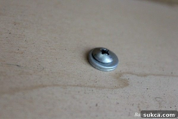 Demonstration of using washers as spacers to fix long screws on furniture hardware