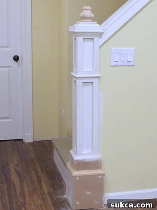 Nearly complete newel post with first finial installed and unfinished stacked base detail