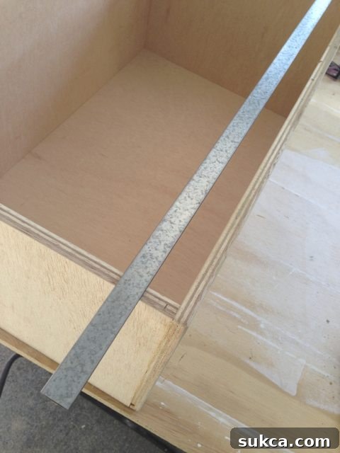 Close-up of metal bars used for hanging file drawers, showing thickness and height