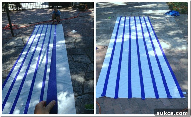 Paint stripes being created An adult and a child (Sophie) working together to spray paint stripes onto a painter's tarp, using Rustoleum paint for an outdoor fabric canopy.