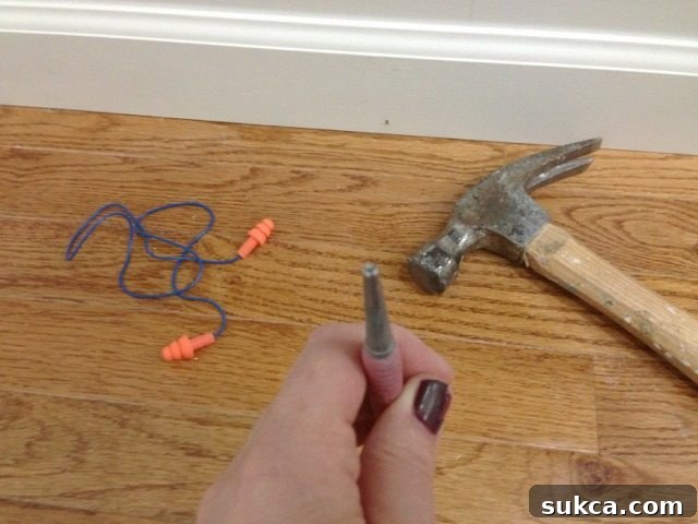 Dimpled tip nail set for secure placement on nail heads