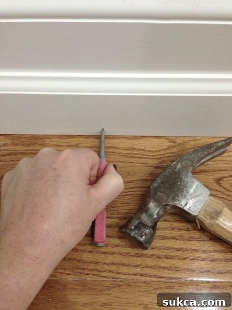 Proper placement of a nail set over a nail head