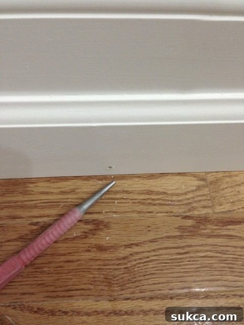 Nail hole after sinking, ready for wood filler