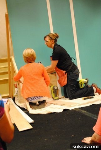 Teamwork on a Plank Wall Project planking a wall with Brittany
