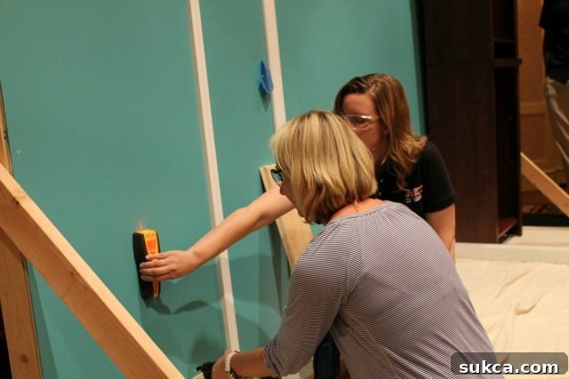 Brittany Demonstrating Stud Finder Use stud finder