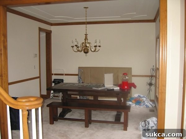 Dated dining room before renovation, showing original paint and flooring.
