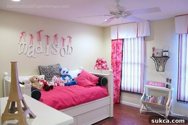 Vibrant pink and zebra themed girl's bedroom, showcasing custom window treatments and unique decor elements.