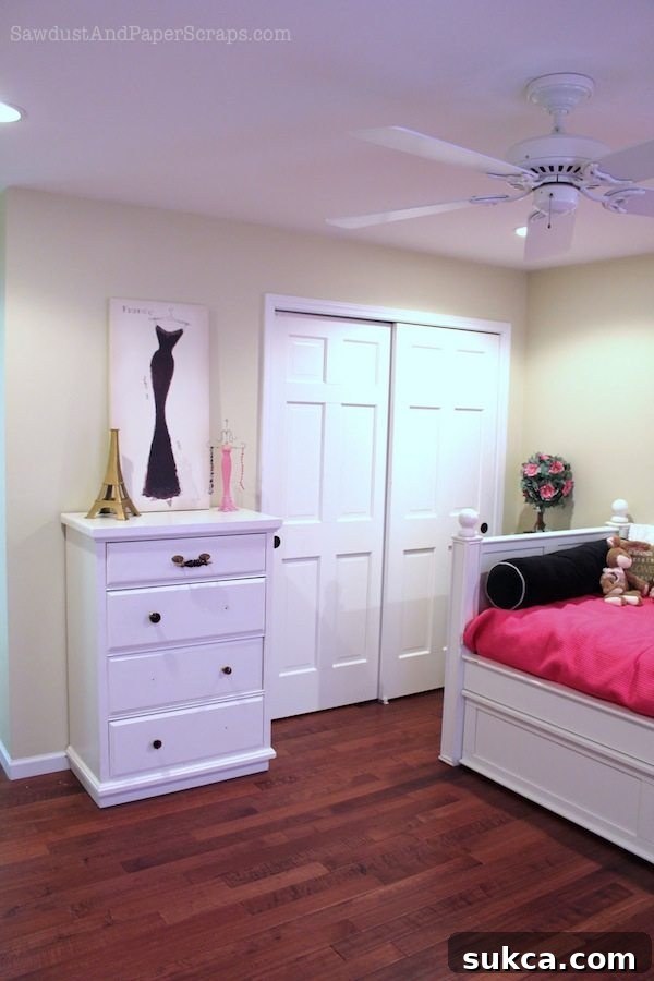 Close-up of a pink dresser in Maddie's bedroom, featuring unique Anthropologie knobs and custom detailing.