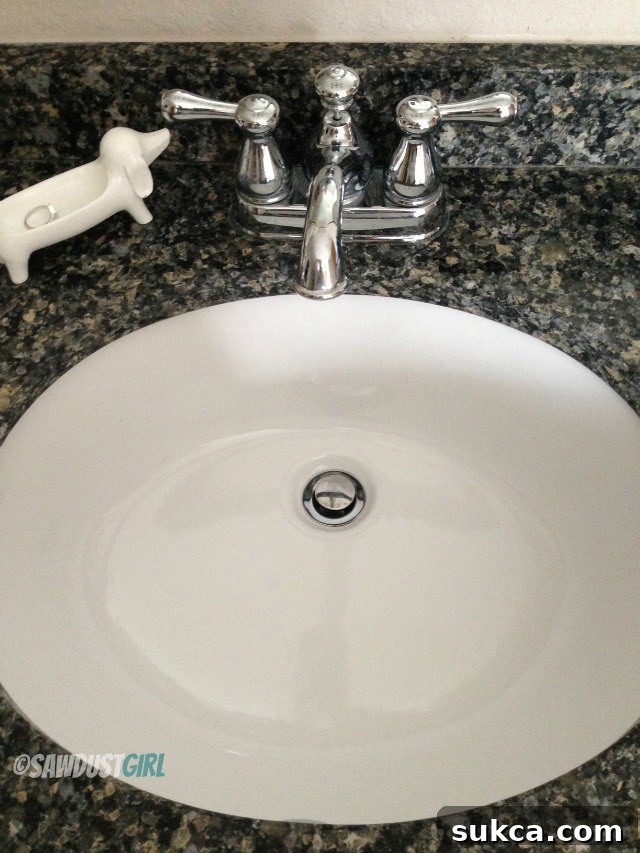 Water flowing freely down a freshly cleared bathroom sink drain, indicating successful clog removal.