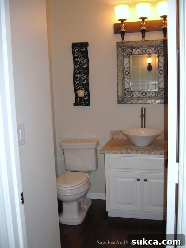 Newly renovated powder room with modern sink, faucet, and mirror