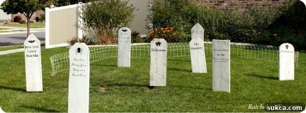 Outdoor Halloween decorations featuring DIY tombstones placed at varied angles in a spooky graveyard scene.