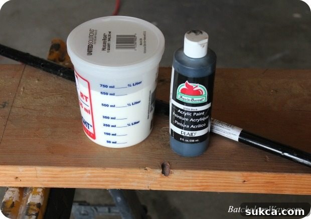 Close-up of materials laid out for DIY Halloween tombstones, including wood, paint, and metal stakes.