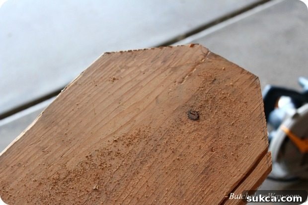 A close-up showing the rustic, unsanded surface of a DIY gravestone before painting, highlighting natural cracks and imperfections.