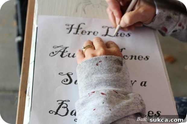 A printed tombstone epitaph being prepared for transfer onto a DIY headstone, showing font selection.