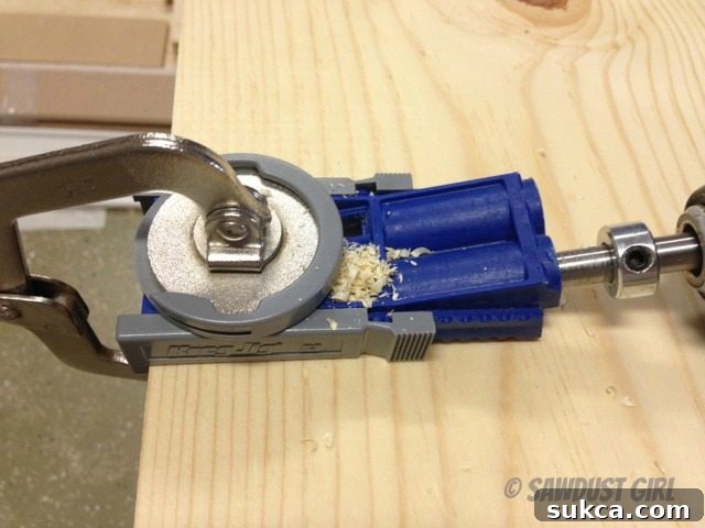 Close-up view of a pocket hole jig barrel showing accumulated sawdust after drilling.
