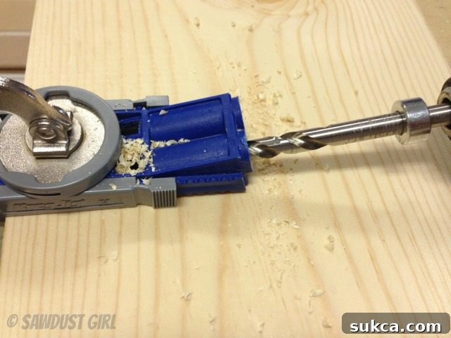 Drill bit being pulled out of a pocket hole while spinning to clear sawdust.