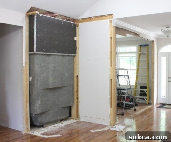 The exposed wall after removing the bathtub, showing the structural changes.