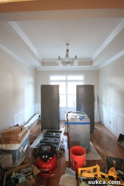 Brand new kitchen appliances delivered and temporarily stored in the transformed dining room, awaiting installation.