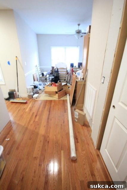 Disorganized temporary kitchen setup in an old dining room, filled with relocated items during the main kitchen renovation.
