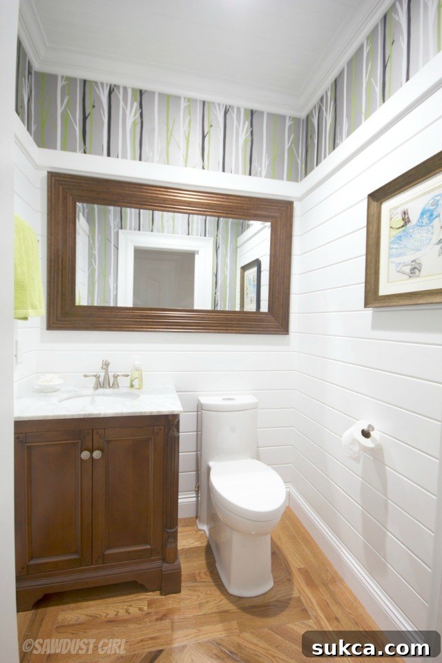 Beautifully decorated powder room featuring a unique mirror, stylish vanity, and carefully chosen accents for a personalized touch.
