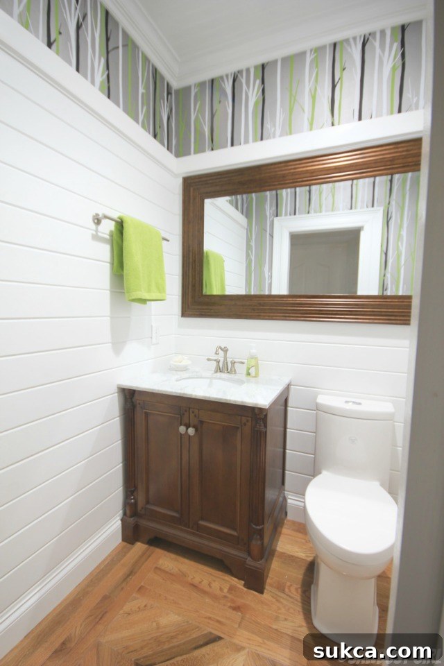 Stylish powder room showcasing modern fixtures, a unique wall treatment, and personal decorative elements.