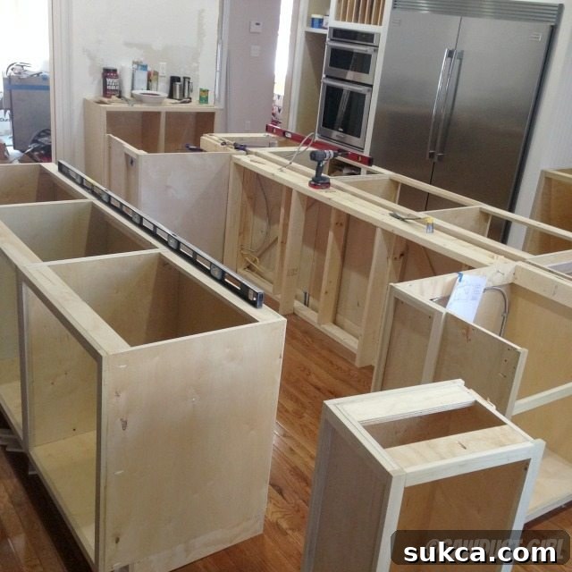 Configuring kitchen island cabinets with pony wall structure visible