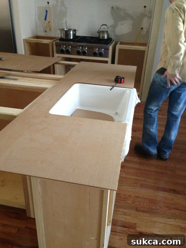Close-up view of the kitchen island during templating, highlighting the precision and skill involved in preparing for countertop installation.
