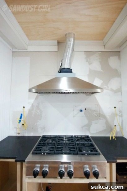 Modern Kitchen Design with Cooktop and Vent Hood