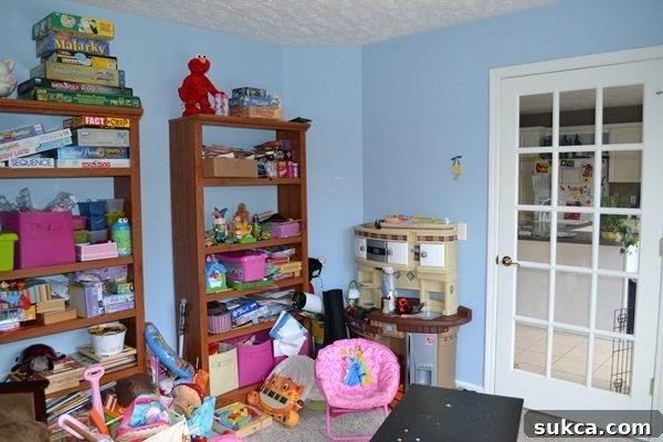 Robin's Playroom Before Before: Robin's Playroom awaiting transformation, showing clutter and lack of storage
