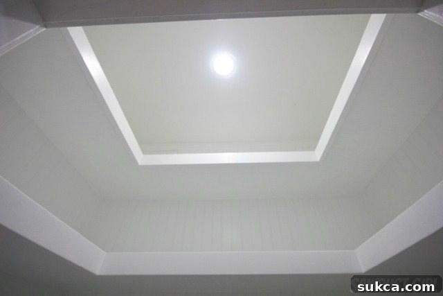 Final result of a DIY project featuring U-shaped floating shelves painted white in a hall closet