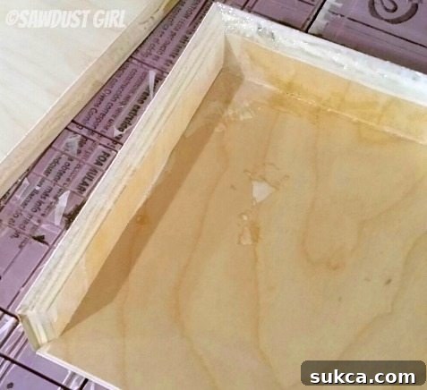 Shelf Assembly with Visible Glue Residue Close-up of a partially assembled floating shelf, showing glue residue and overall construction