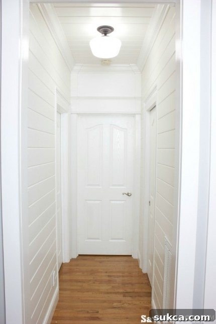 Finished living room hallway with plank walls